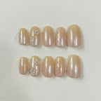 Golden Hour Handmade Press-On Nails — nude gold shimmer with floral accents on short oval shape | MOONLEE