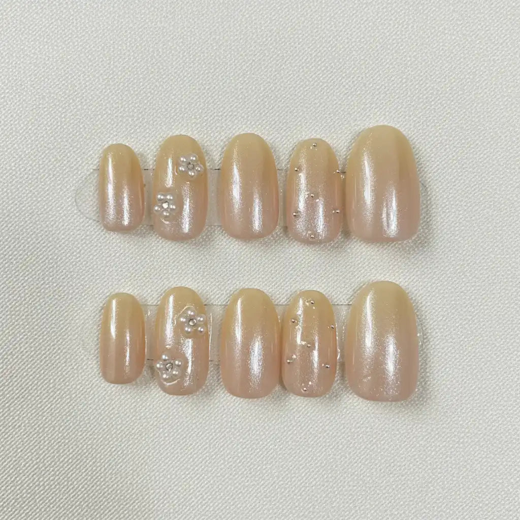 Golden Hour Handmade Press-On Nails — nude gold shimmer with floral accents on short oval shape | MOONLEE